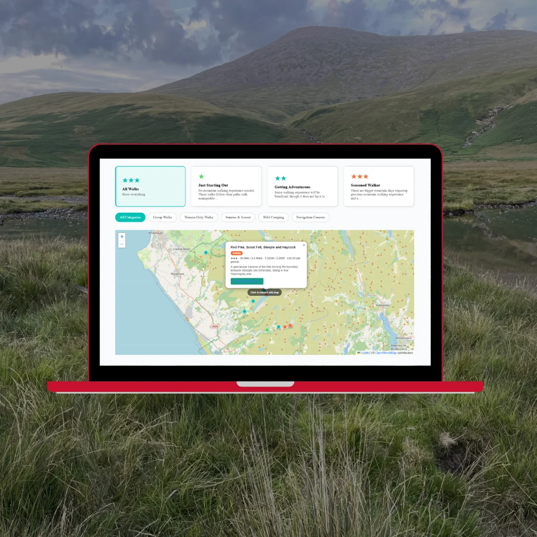 Way Out West activities and interactive map on red laptop showing walk routes and activity pins across the Lake District against moorland fells