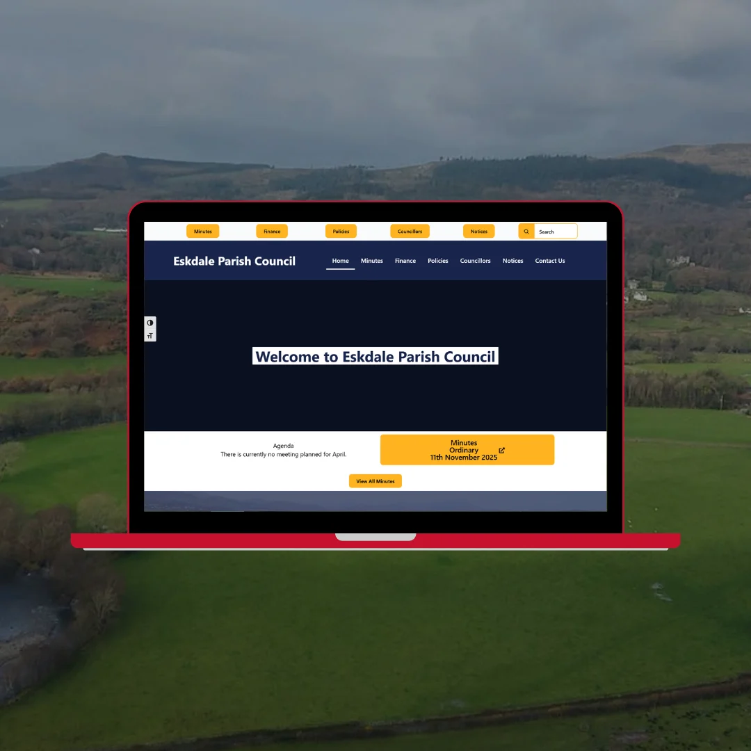 Eskdale Parish Council website on red laptop showing council homepage with navigation and information sections against Lake District backdrop