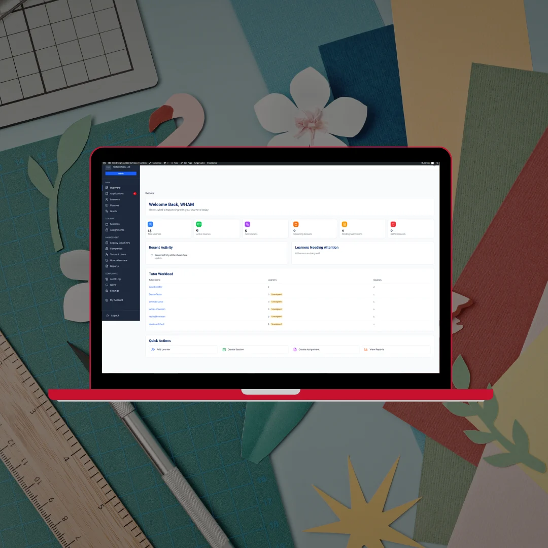 South Cumbria Skills Exchange learner management system admin dashboard on red laptop against colourful paper craft background
