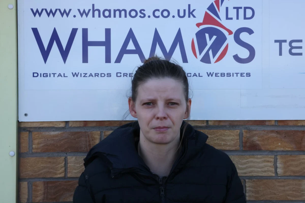 Maria in front of Whamos sign